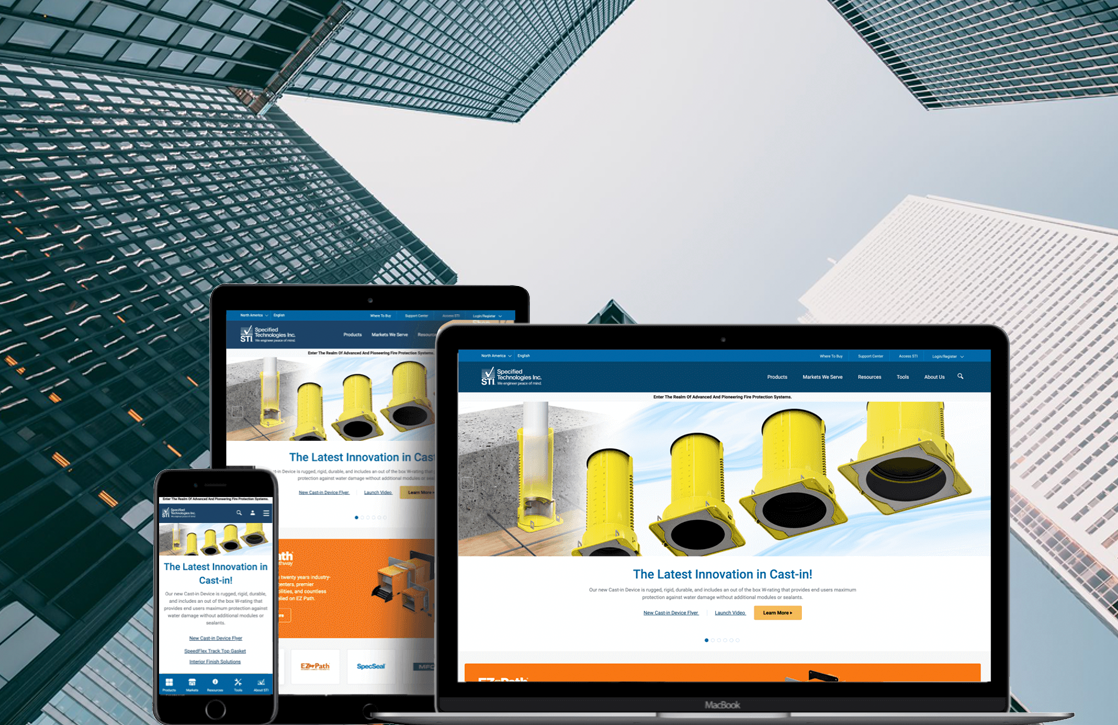 Specified Technologies (STI) website shown on desktop, laptop and mobile against a skyscraper backdrop